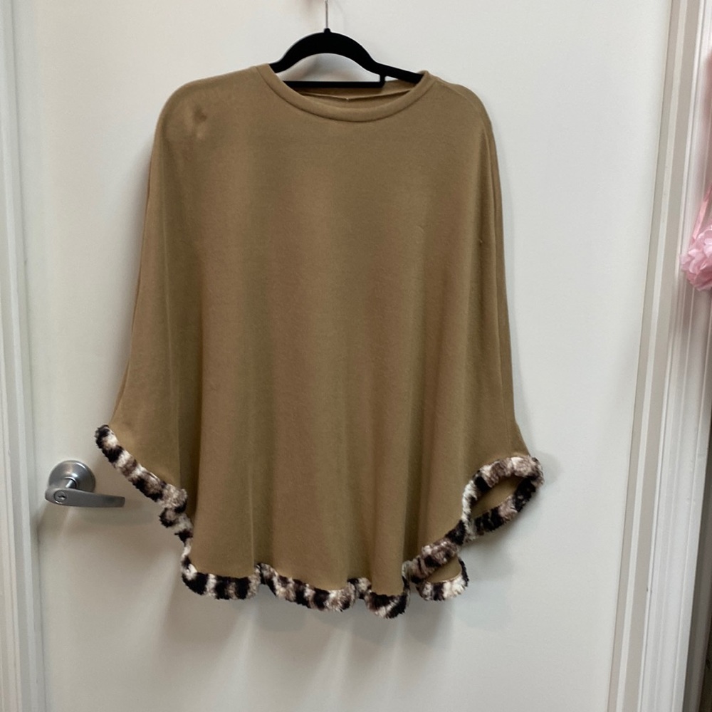 Tan cape with faux fur look at the hem.